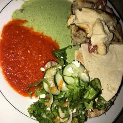 A picture of Gurasa with salad and tomato stew with cucumber.