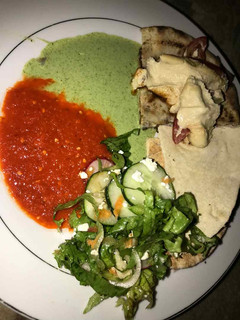 A picture of Gurasa with salad and tomato stew with cucumber.