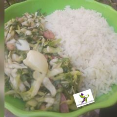 A picture of White rice with cabbage sallad.