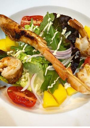 A picture of Lime, chilli prawns on mango salad.