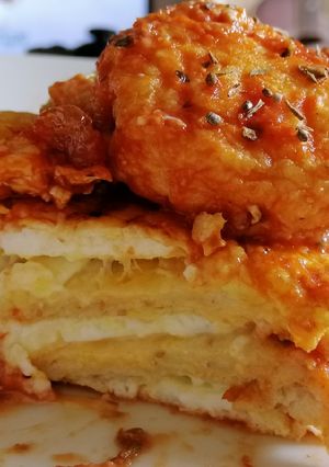 A picture of Cheese Toastie with Fried Eggs topped with Salsa Sauce.
