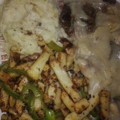 A picture of Lamb steak with mushroom sauce stir fried vegis and mashed potatoes.