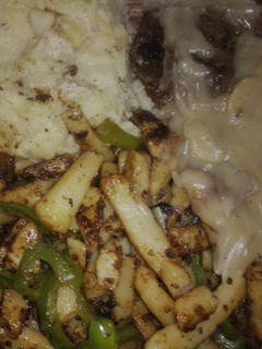 A picture of Lamb steak with mushroom sauce stir fried vegis and mashed potatoes.