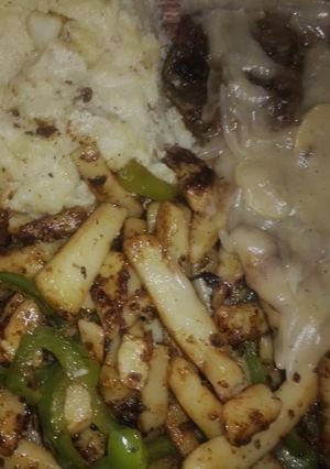 A picture of Lamb steak with mushroom sauce stir fried vegis and mashed potatoes.