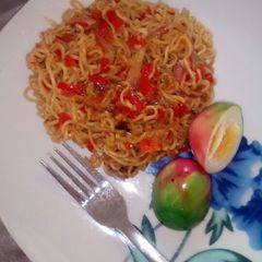 A picture of Indomie with boiled coloured egg.