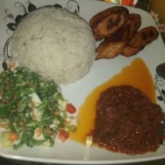 A picture of Rice stew with salad & plantain.