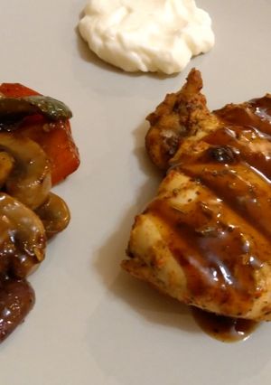 A picture of Grilled chicken breasts with barbeque sauce.