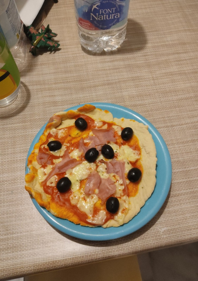 Una foto de Pizza de aceitunas y jamón en panificadora