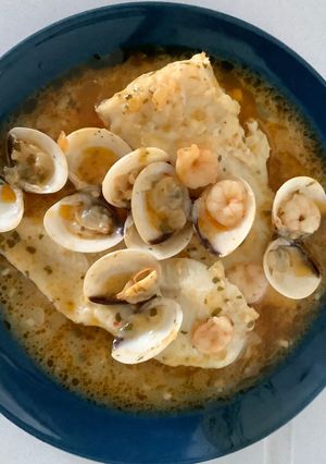 A picture of Hake in Green Sauce with Clams and Shrimp.