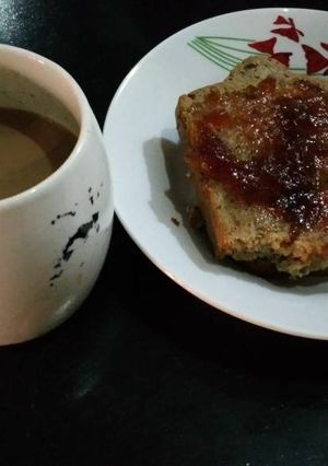 A picture of Sliced bread with jam and coffee.