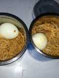 Jollof spaghetti and boiled egg