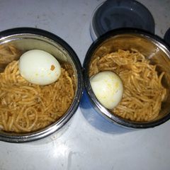 Jollof spaghetti and boiled egg A picture of Jollof spaghetti and boiled egg.
