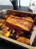 Roast pork belly with herb infused roast new potatoes and spring greens