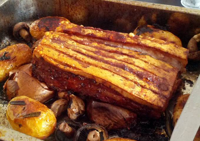 Roast pork belly with herb infused roast new potatoes and spring greens