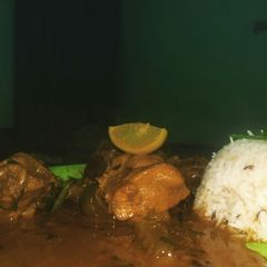 A picture of Northern style chicken curry with zeera rice.
