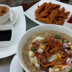 A picture of Chicken corn soup with chicken crispy strips.