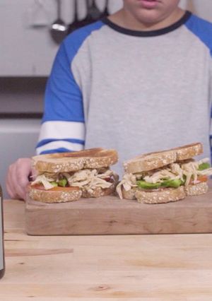 A picture of Shredded chicken, paprika and avocado sandwich.