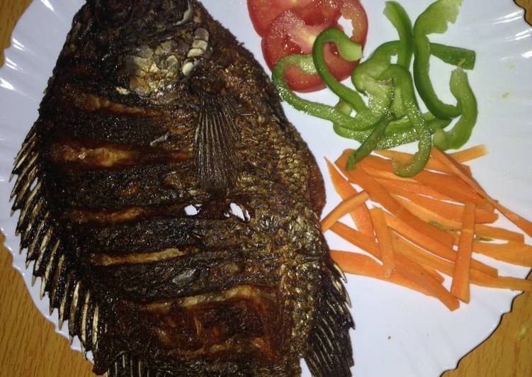 Award-winning Deep fried fish garnished with green pepper, carrots and tomatoes