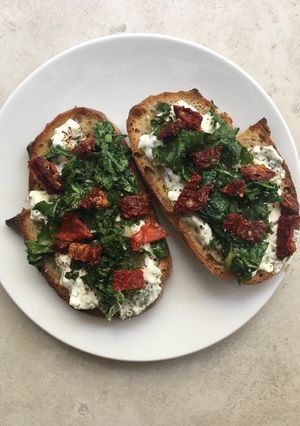 A picture of Cottage cheese and spinach on toast.