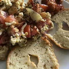 A picture of Sliced bread with scrumble egg and cabbage.