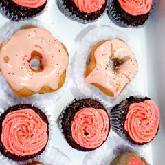 A picture of Moist Chocolate Cupcakes and glazed donuts.