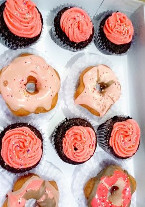 A picture of Moist Chocolate Cupcakes and glazed donuts.