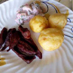A picture of Deep fried potatoes, deep fried beef and salad.