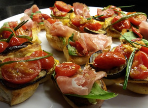 Una foto de Bocaditos de Bondiola, rúcula y cherry/ Entrada