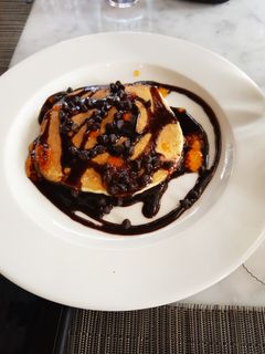 A picture of Banana pancakes with chocolate sauce.