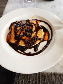 A picture of Banana pancakes with chocolate sauce.