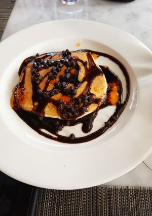 A picture of Banana pancakes with chocolate sauce.