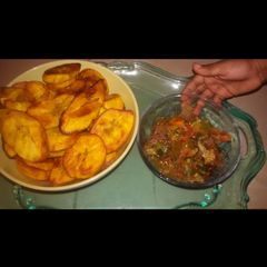 A picture of Fried plantain served with  titus fish and vegetable sauce.