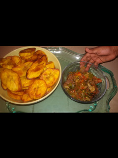 A picture of Fried plantain served with titus fish and vegetable sauce.