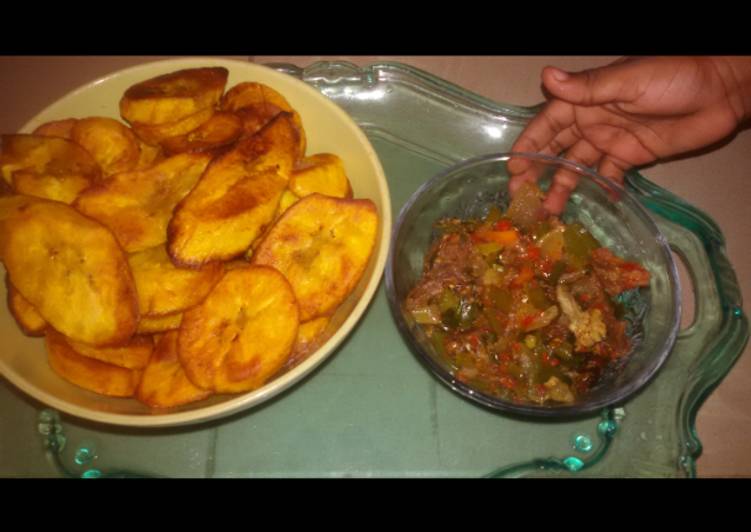 Fried plantain served with  titus fish and vegetable sauce