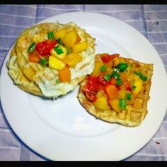 A picture of Waffles and Omellet topped with glazed Honey Tomato Mango Salsa.