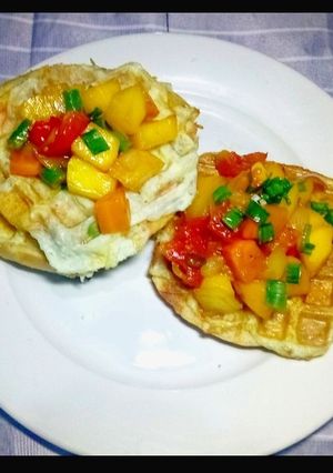 A picture of Waffles and Omellet topped with glazed Honey Tomato Mango Salsa.