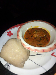 A picture of Eba and my local beans soup slightly garnished with scent leaves.