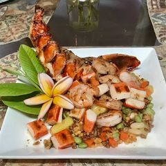 A picture of Grilled seafood with a tropical blend of high protein veggies.