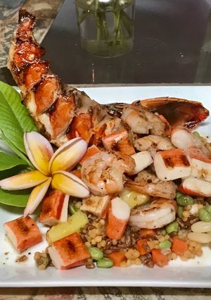 A picture of Grilled seafood with a tropical blend of high protein veggies.