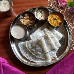 A picture of Neerudosa,sweet coconut milk,chutney,& coconut jaggery mix.