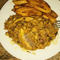 A picture of Porriage beans with fried plantain and smoked fish.