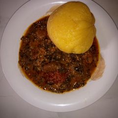 A picture of Eba and ugwu soup.