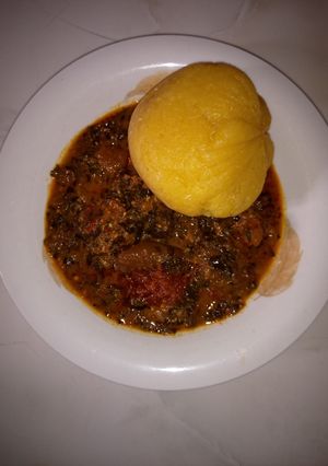 A picture of Eba and ugwu soup.