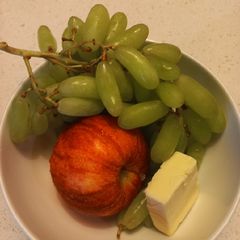 A picture of Apple, grape, cheese snack.