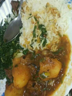 A picture of Beef Stew with Waru, Served with Rice and Saute kales.