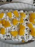 Brazo gitano con crema chantilly, dulce de leche y melocotones