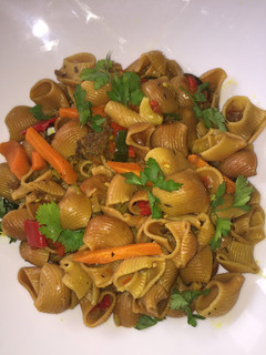A picture of Fried macaroni with minced meat garnish with fresh parsely.