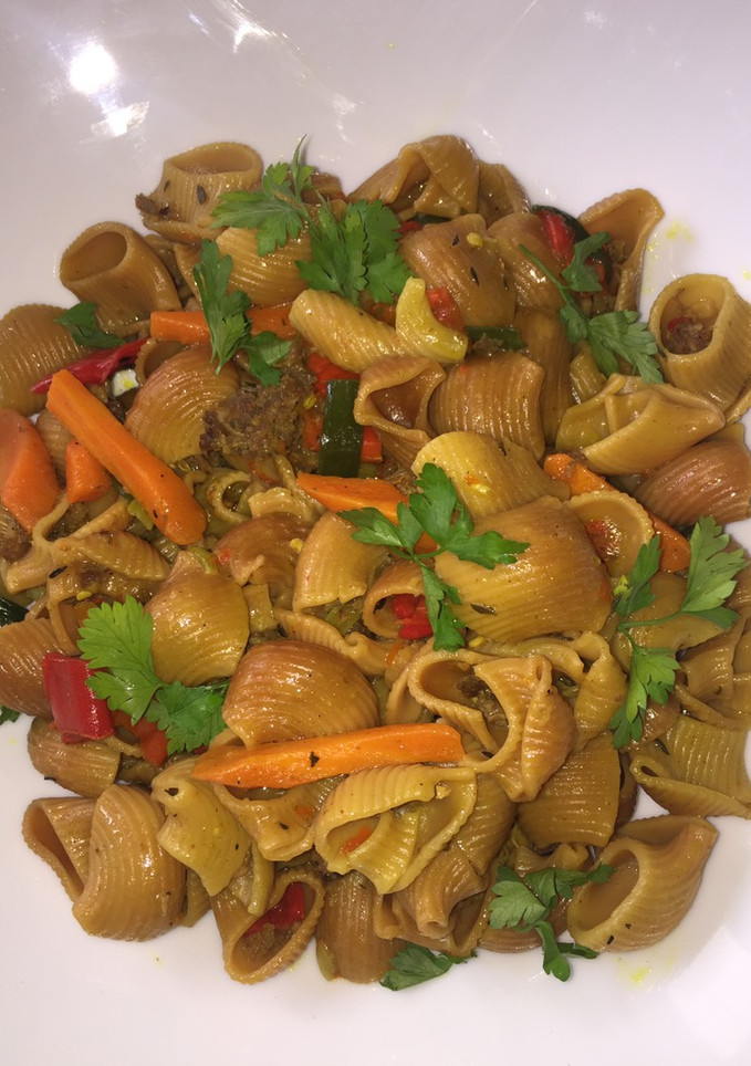 A picture of Fried macaroni with minced meat garnish with fresh parsely.