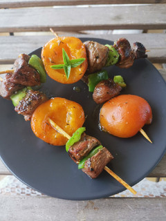 A picture of Duck Skewers with Honey and Candied Apricots.