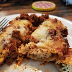 A picture of Stuffed Manicotti with Meat Sauce.